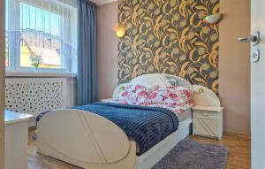 a small bedroom with a bed and a wall at Nice Home In Szczecin With Wifi in Szczecin