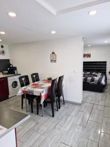 a dining room with a table and chairs and a bed at Joli Studio in Metz +4 photos