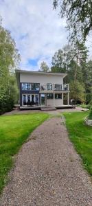 a large white house with a large yard at Koivuniemen Tila 3 in Säkylä