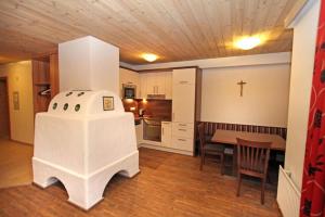 a kitchen with a table and a cross on the wall at Ferienwohnung Königsleiten 2 - Top 3 in Königsleiten