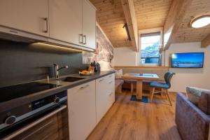 a kitchen with a sink and a table at Ferienwohnung 73 - Top Bergkristall in Wald im Pinzgau