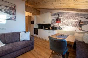 a living room with a couch and a table at Ferienwohnung 73 - Top Bergkristall in Wald im Pinzgau