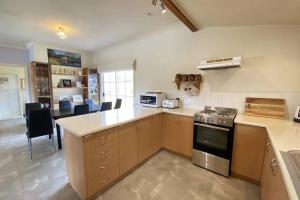 a kitchen with a stove and a counter top at Beautiful vineyard stay in Howrah