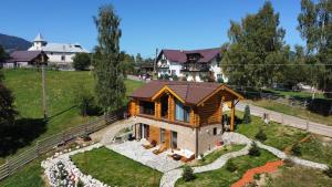 an overhead view of a log house in a field at MaviLand Chalet in Bran