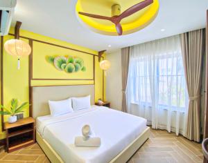 a bedroom with a bed with a statue on it at Sujet Hotel Da Nang in Danang