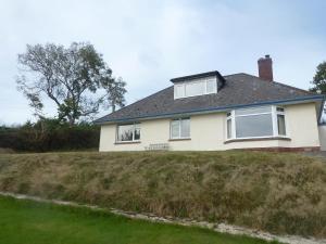 a house on top of a grassy hill at Briardene Cottage - Devon countryside - sleeps 6 in Exeter