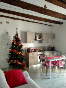 a christmas tree in a kitchen with a table and chairs at La casa nel Borgo Sospeso "con vista panoramica" in Vitorchiano +32 photos