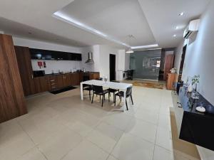 a large kitchen with a white table and chairs at Unique apartment and location in Vittoriosa