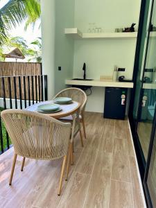 a dining room with a table and two chairs at Eterno Villas in Salad Beach