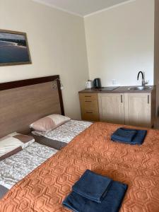 a bedroom with two beds with towels on them at Kornelija in Palanga