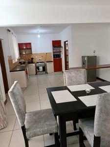 a kitchen and dining room with a table and chairs at Chelsi Homes in Shanzu