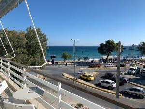 a view of a parking lot and the ocean at Starfish Vacation Rentals - Athens Int. Airport in Artemida