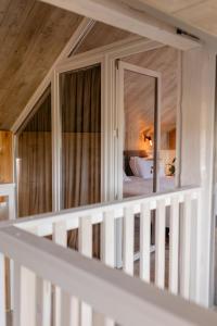 a white room with a bed and a mirror at UGRAD family котедж з чаном-джакузі in Slavske +115 photos
