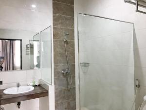 a bathroom with a shower and a sink at Selorejo Resort Mitra RedDoorz in Sekar +35 photos