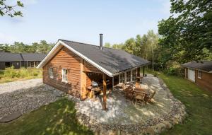 a small log cabin with a table and chairs in the yard at 3 Bedroom Gorgeous Home In Skals in Skals