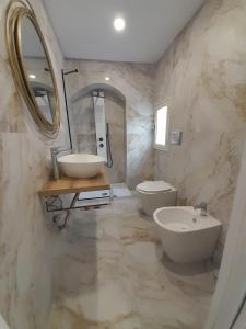 a bathroom with a sink and a toilet and a mirror at Fuoco dell'Etna in Catania