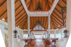 a large room with chairs and a ceiling with wood at BP Chiangmai City Hotel in Chiang Mai