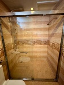 a glass shower in a bathroom with a toilet at Sands Grand in Dhigurah +58 photos