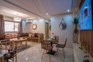 un soggiorno con un divano e un tavolo di Aliya Luxury Apartment - CORAIL - AGADIR ad Agadir