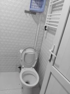 a small bathroom with a toilet and a staircase at Lili's Flat in Angisa +6 photos