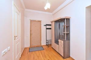 an empty hallway with a door and a chair at Cozy appartement in big center in Yerevan +6 photos