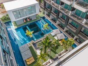 an overhead view of a building with a swimming pool and palm trees at Sugar Marina Hotel - FASHION - Kata Beach in Kata Beach