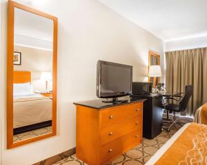 a hotel room with a television and a bedroom at Comfort Inn in Edmundston