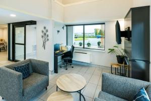 an office with two chairs and a desk and a table at Comfort Inn in Charlottetown
