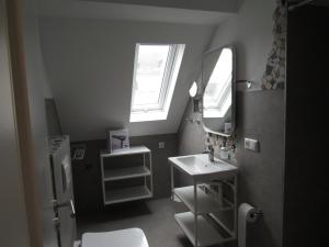 a small bathroom with a sink and a mirror at Ferienwohnungen Rheinhöhe in Sankt Goar +2 photos