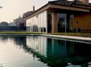 a pool of water in front of a building at Chalet Puerto Sherry in El Puerto de Santa María