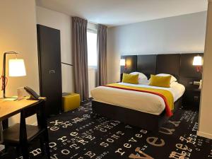 a hotel room with a bed and a desk at Best Western Plus Thionville Centre in Thionville