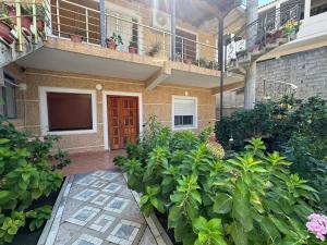 a courtyard of a building with a bunch of plants at Hills Villa in Vlorë