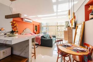 a kitchen and living room with a table and chairs at Aconchego em sampa in São Paulo