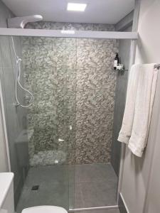 a shower with a glass door in a bathroom at Aconchego em sampa in Sao Paulo
