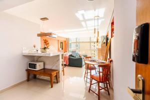 a kitchen and living room with a table and chairs at Aconchego em sampa in Sao Paulo +36 photos