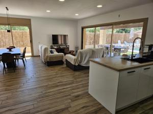 a kitchen and living room with a table and chairs at Utopia in Puigventos