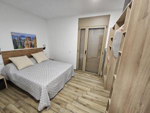 a bedroom with a bed and a wooden floor at Utopia in Puigventos +31 photos