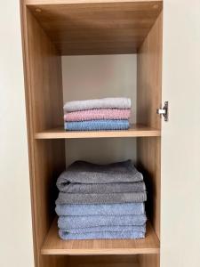 a group of towels in a wooden cabinet at BarSUN in Bar