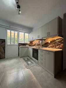 a kitchen with white cabinets and a counter top at Joanna s apartment in Petalidi