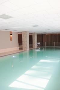 an empty dance floor in a room with blue lights at Silva Hotel Spa-Balmoral in Spa +33 photos