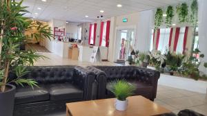a black leather couch in a store with plants at Heathlands Hotel in Bournemouth