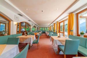 a dining car of a train with tables and chairs at Hotel St. Pankraz in San Pancrazio dʼUltimo