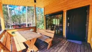 a wooden bench on the porch of a cabin at Chata Marzeń Classic in Wólka