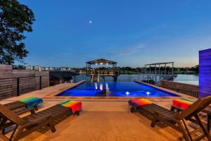 a swimming pool on top of a building with two chairs at The High Life with Concierge Services in Kingsland