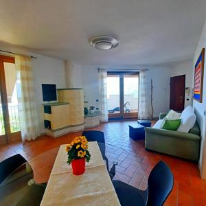 a living room with a table with flowers on it at relaxing green panorama in Margno