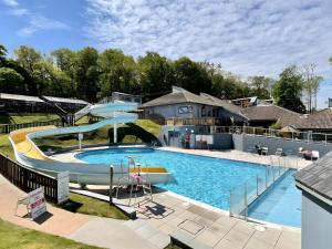 a large swimming pool with a water slide at Lodge Nine in Newton Abbot