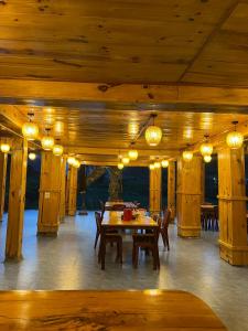 a dining room with a table and chairs and lights at Muong Tra Stream Homestay in Làng Cac +8 photos