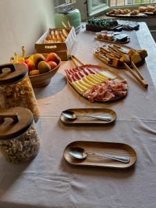 a table topped with plates of food and spoons at Locanda La Motta in Motta Baluffi