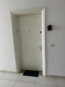 a white door in a room with a tile floor at Apartment Center in Shkodër