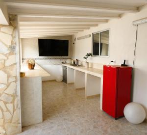 a kitchen with a red refrigerator in a room at 195 sqm luxury apartment in L'Alfas del Pi
